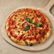 Margherita sourdough pizza on a wooden pizza peel